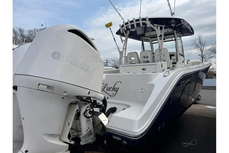 Slide: The Image of 2017 Cobia 344 Center Console boat with Yamaha engine, docked outdoors. - 2