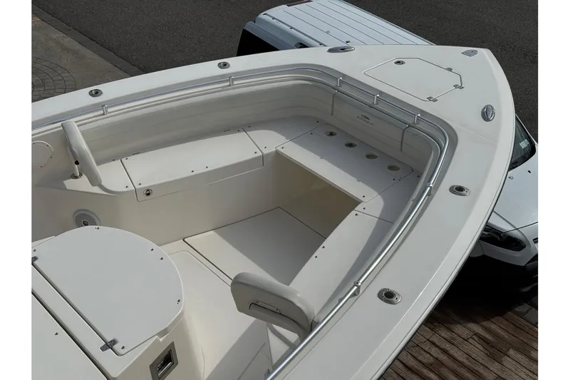 Slide: The Image of 2017 Cobia 344 Center Console boat, spacious deck view with seating and storage compartments. - 3
