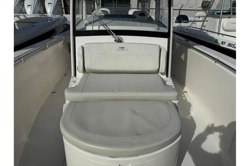 Slide: The Image of 2017 Cobia 344 Center Console boat interior with cushioned seating and sleek design. - 5