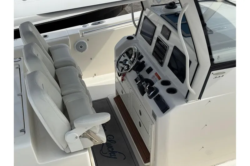 Slide: The Image of 2017 Cobia 344 Center Console boat interior with steering wheel and control panel. - 6