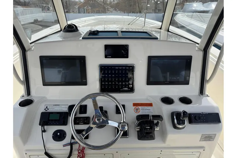Slide: The Image of 2017 Cobia 344 Center Console helm with dual Garmin displays and steering wheel. - 8