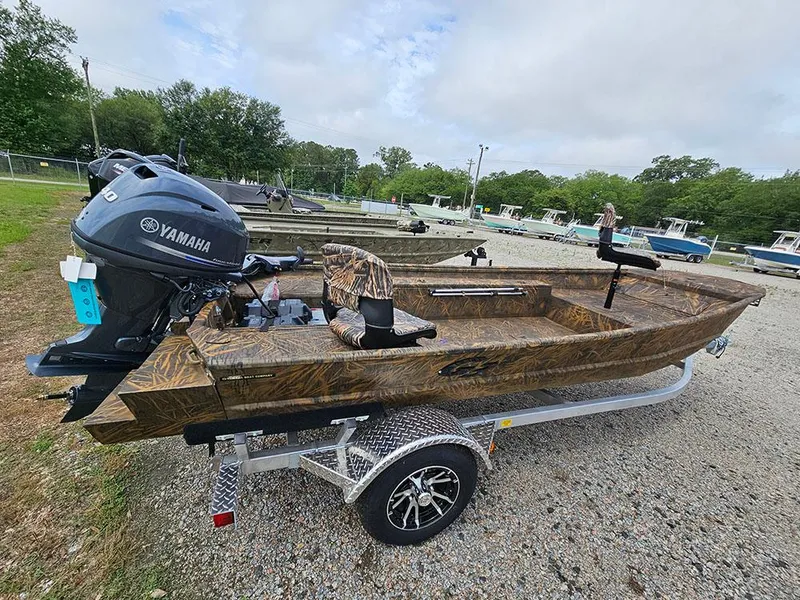 The Image of 2025 G3 Gator Tough 15 DK boat with Yamaha motor on trailer, parked outdoors. - 0