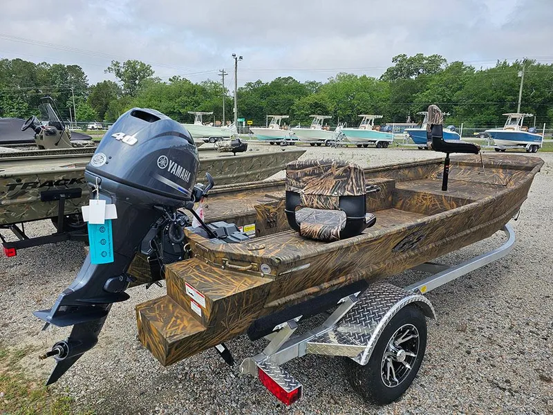 Slide: The Image of 2025 G3 Gator Tough 15 DK boat with Yamaha motor on trailer, camo design. - 1
