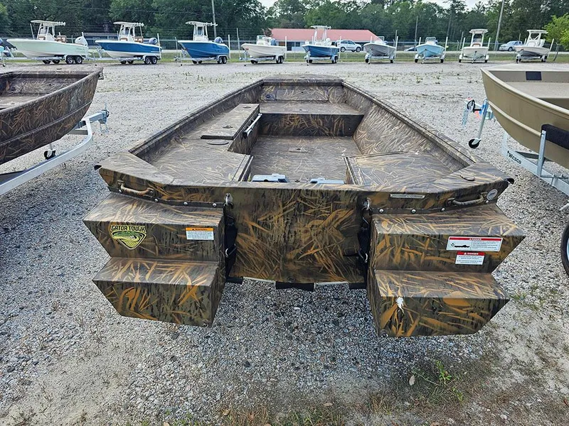 Slide: The Image of 2025 G3 Gator Tough 15 DK boat with camouflage design, parked on gravel lot. - 14