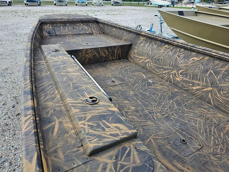 Slide: The Image of 2025 G3 Gator Tough 15 DK boat with camouflage interior, parked on gravel. - 16