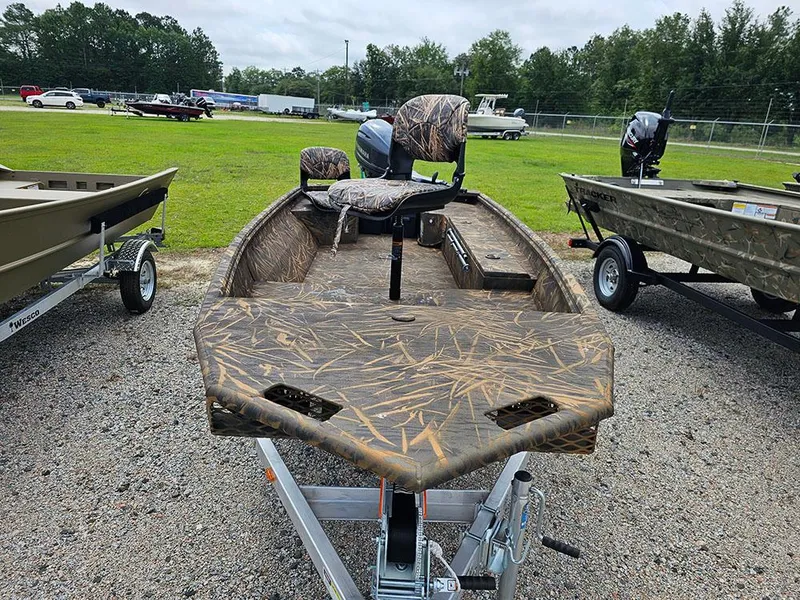 Slide: The Image of 2025 G3 Gator Tough 15 DK boat with camouflage design on a trailer. - 2