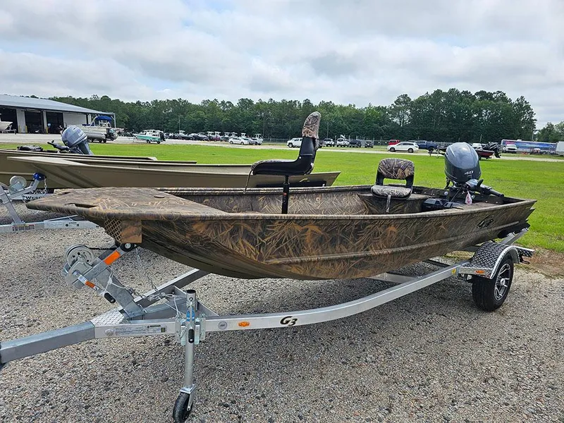Slide: The Image of 2025 G3 Gator Tough 15 DK boat on trailer, camo design, outdoor setting. - 3