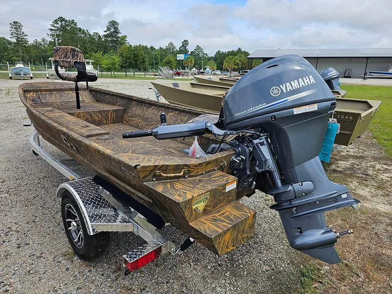 Slide: The Image of 2025 G3 Gator Tough 15 DK boat with Yamaha motor on trailer, outdoors. - 5