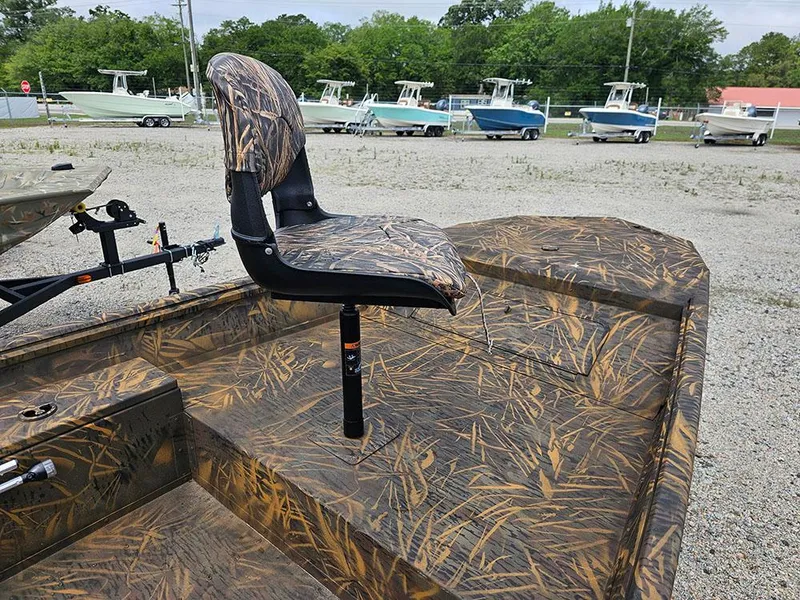 Slide: The Image of 2025 G3 Gator Tough 15 DK boat with camo seat and deck, parked outdoors. - 7