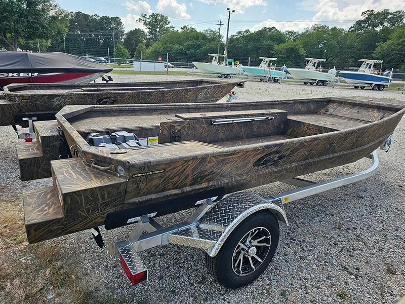 Slide: The Image of 2025 G3 Gator Tough 15 DK boat on trailer, camo design, parked outdoors. - 9