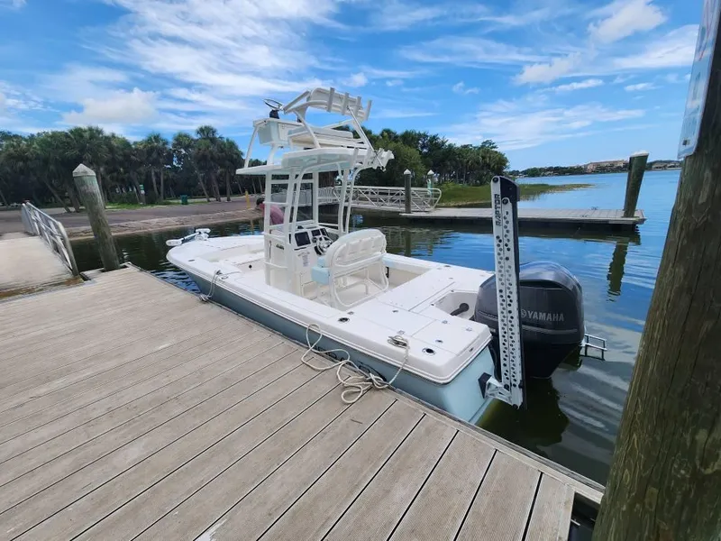 Slide: The Image of 2020 Robalo 246 Cayman boat docked at a marina with Yamaha engine. - 18
