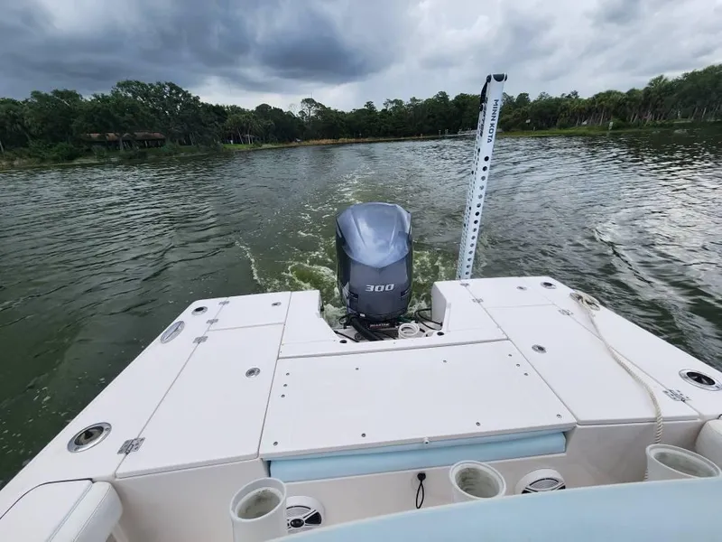Slide: The Image of 2020 Robalo 246 Cayman boat on water, rear view with outboard motor. - 20
