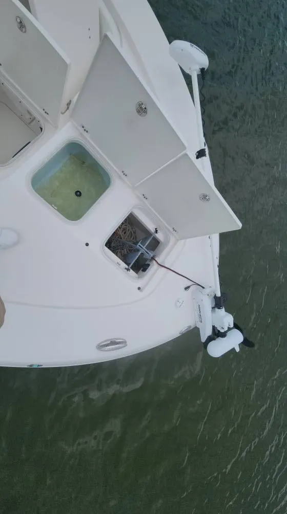 Slide: The Image of 2020 Robalo 246 Cayman boat deck with open storage compartments, viewed from above. - 21