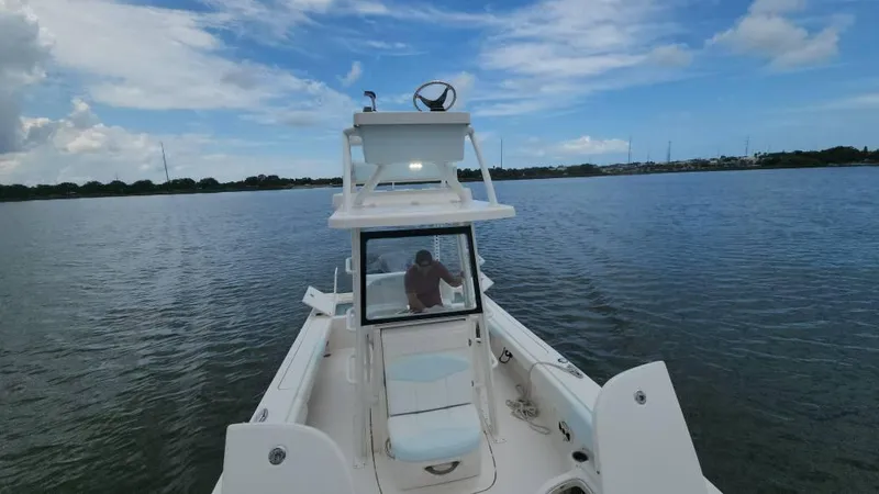 Slide: The Image of 2020 Robalo 246 Cayman boat on calm water under a partly cloudy sky. - 24