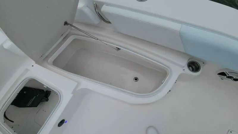 Slide: The Image of 2020 Robalo 246 Cayman boat storage compartment with open hatch and seating area. - 27