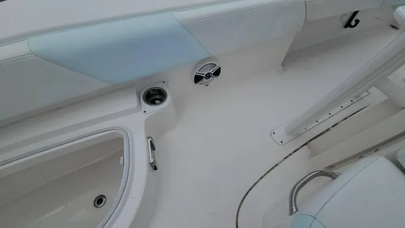 Slide: The Image of Interior of 2020 Robalo 246 Cayman boat, featuring seating and storage compartments. - 34