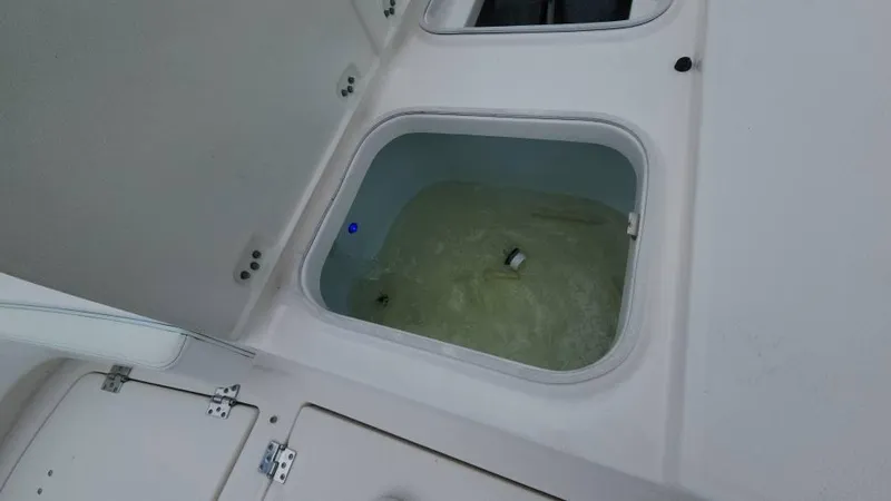 Slide: The Image of Livewell compartment on a 2020 Robalo 246 Cayman boat, filled with water. - 35