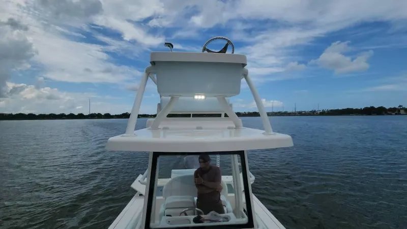 Slide: The Image of 2020 Robalo 246 Cayman boat on calm water under a partly cloudy sky. - 37