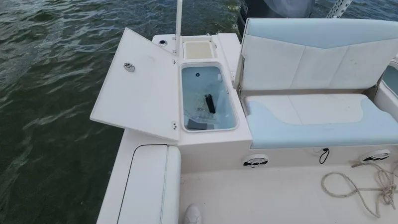 Slide: The Image of 2020 Robalo 246 Cayman boat interior with open storage compartment and seating. - 38