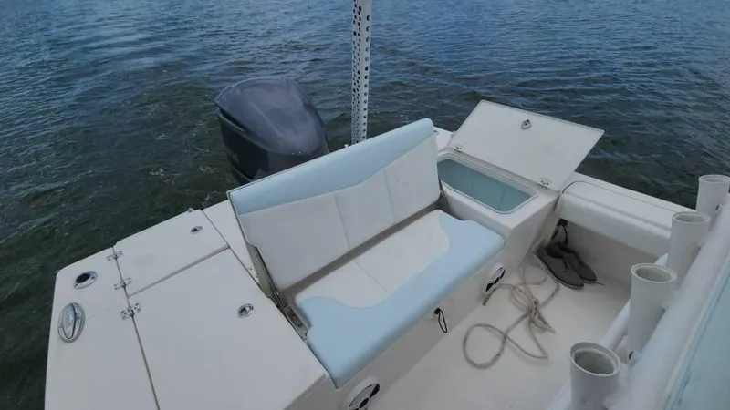 Slide: The Image of 2020 Robalo 246 Cayman boat interior with seating and storage, on calm water. - 39
