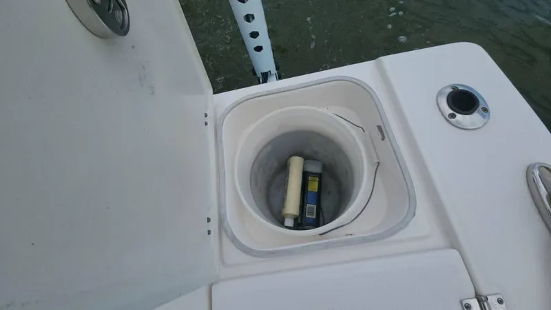Slide: The Image of Open storage compartment on 2020 Robalo 246 Cayman boat with items inside. - 41