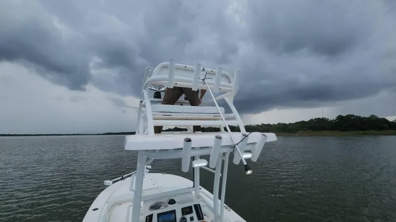 Slide: The Image of 2020 Robalo 246 Cayman boat on water under cloudy sky. - 43