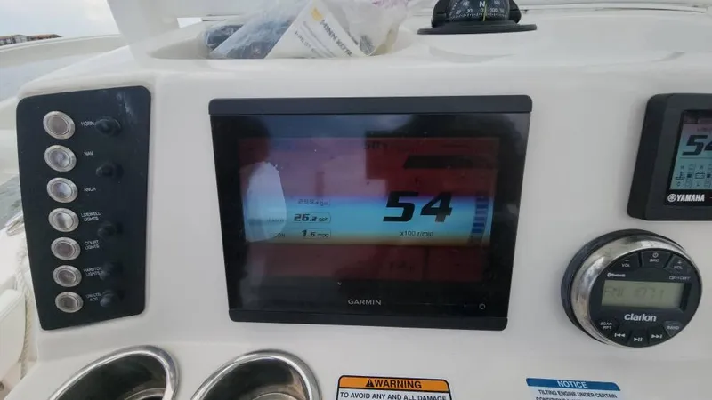 Slide: The Image of Dashboard of 2020 Robalo 246 Cayman boat with Garmin display and controls. - 47