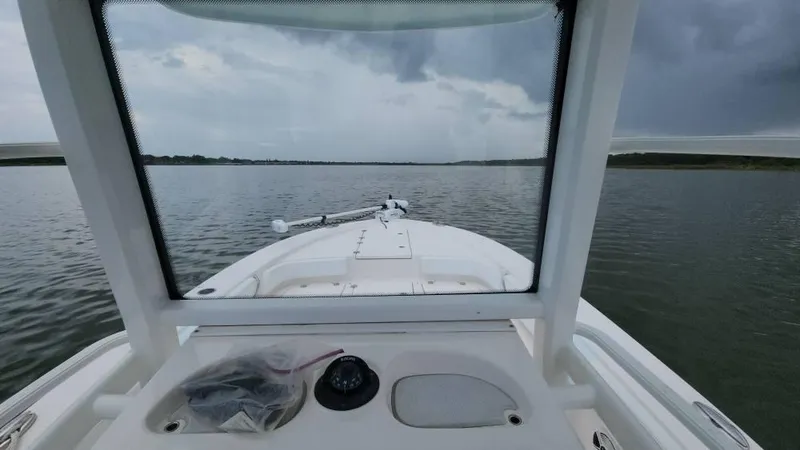 Slide: The Image of 2020 Robalo 246 Cayman boat on calm water under cloudy sky. - 48