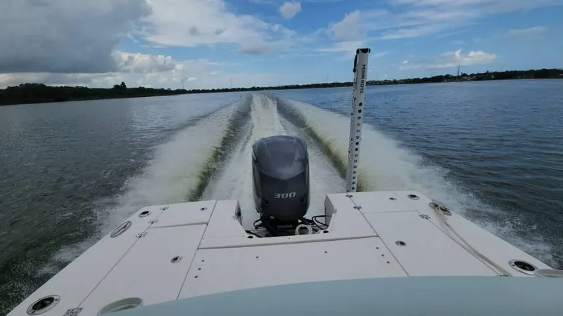 Slide: The Image of Robalo 246 Cayman 2020 boat cruising on a lake under a partly cloudy sky. - 49