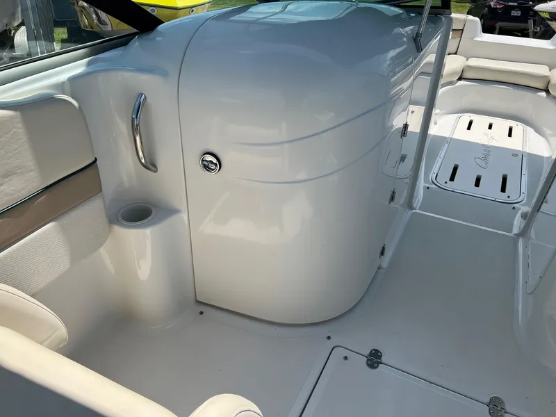 Slide: The Image of Interior of 2000 Chris-Craft 260DB boat, featuring sleek white design and seating area. - 10