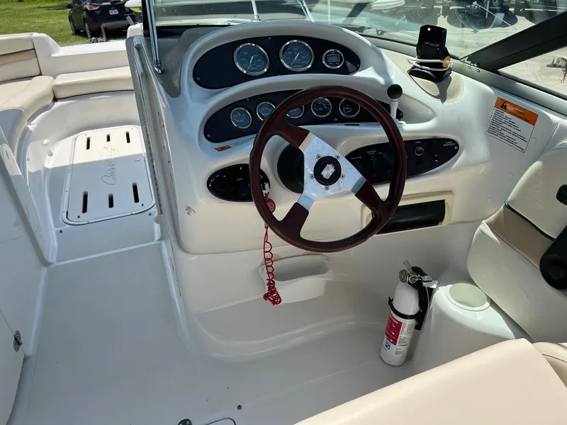 Slide: The Image of Cockpit of 2000 Chris-Craft 260DB boat with steering wheel and control panel. - 11