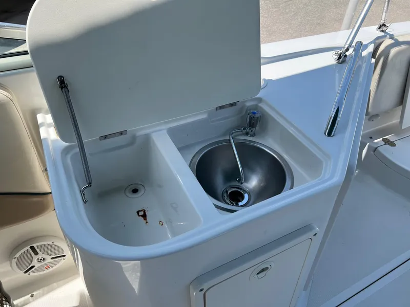 Slide: The Image of Chris-Craft 260DB 2000 boat sink and storage area with open lid. - 15