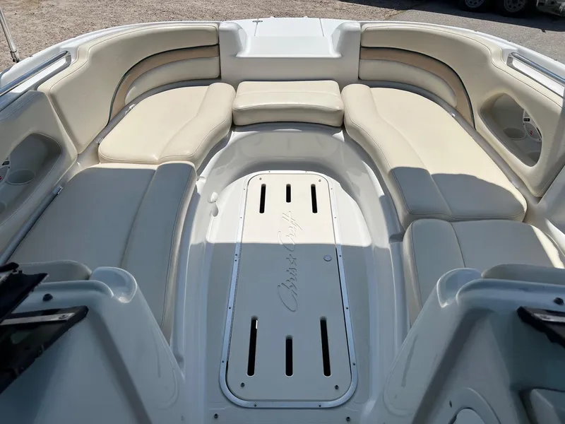 Slide: The Image of Spacious seating area on a 2000 Chris-Craft 260DB boat, featuring beige upholstery. - 19