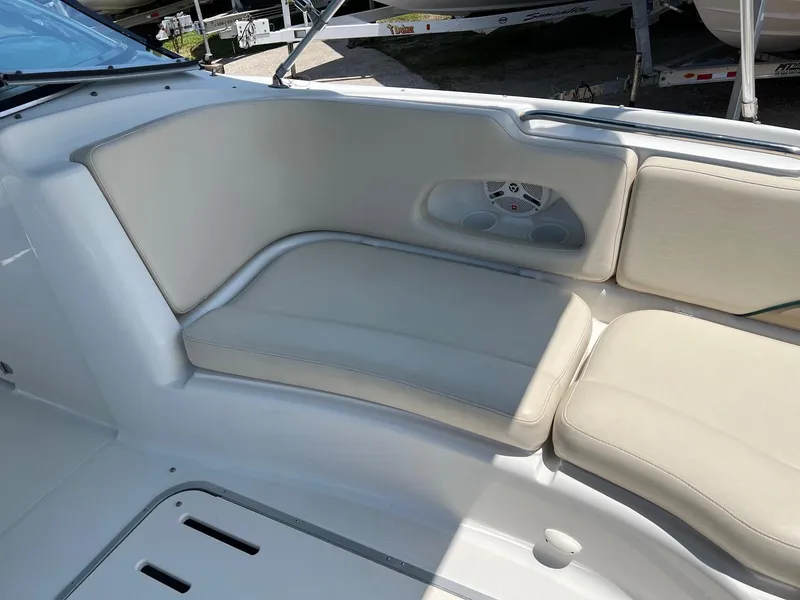 Slide: The Image of Cream-colored seating on a 2000 Chris-Craft 260DB boat, featuring a built-in speaker. - 20