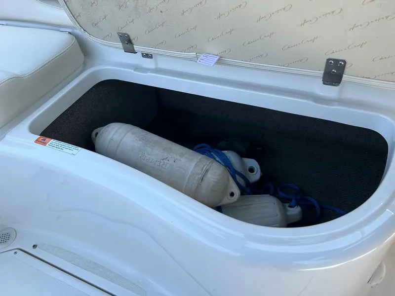 Slide: The Image of Storage compartment on a 2000 Chris-Craft 260DB boat with fenders inside. - 28