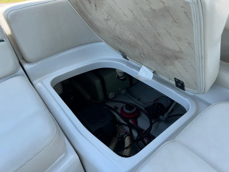 Slide: The Image of Open storage compartment on 2000 Chris-Craft 260DB boat, revealing interior components. - 29