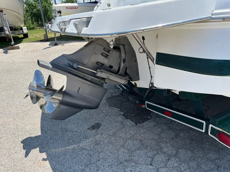 Slide: The Image of 2000 Chris-Craft 260DB boat stern with propeller, parked on a trailer. - 32