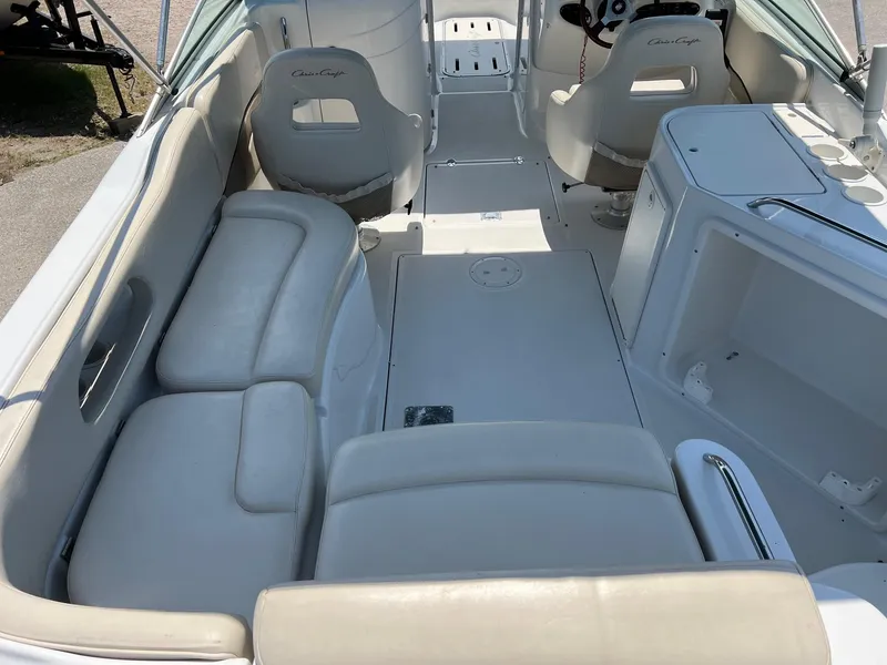 Slide: The Image of Interior of a 2000 Chris-Craft 260DB boat with beige seating and helm. - 9