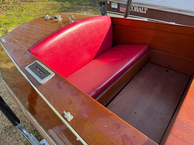 Slide: The Image of 1932 Chris-Craft 301 boat interior with red leather seat and wooden finish. - 11