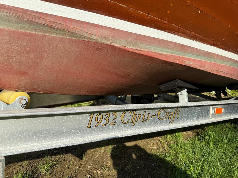 Slide: The Image of 1932 Chris-Craft 301 boat on trailer, close-up view of hull and trailer text. - 12