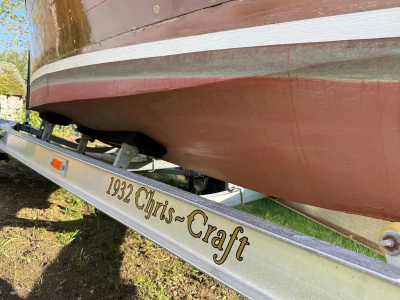 Slide: The Image of 1932 Chris-Craft 301 boat on trailer, showcasing vintage wooden hull design. - 13
