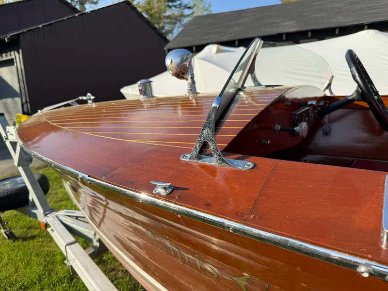 Slide: The Image of 1932 Chris-Craft 301 wooden boat with polished chrome details on a trailer. - 2