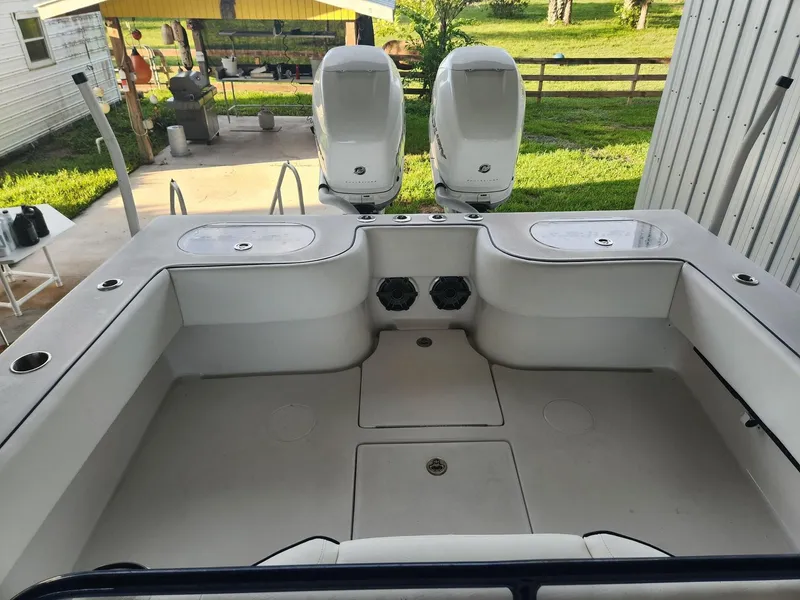 Slide: The Image of 2013 SeaHunter 35 Tournament boat deck with dual engines, outdoor setting. - 10