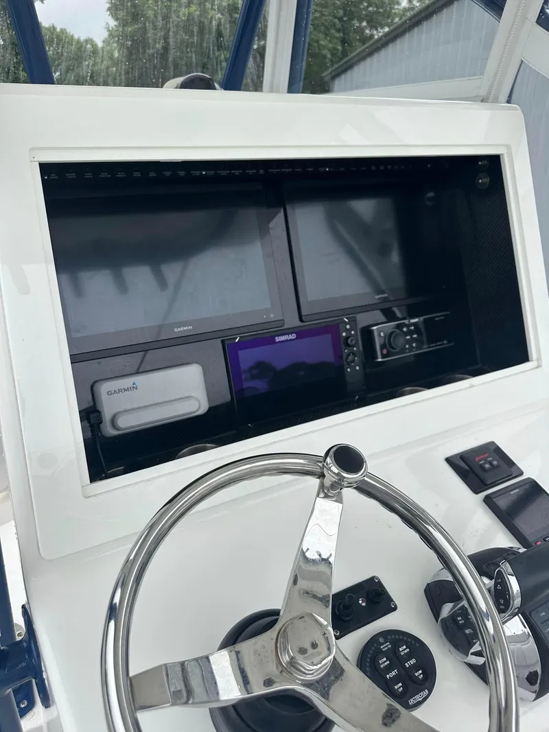 Slide: The Image of 2013 SeaHunter 35 Tournament dashboard with steering wheel and electronic navigation displays. - 12