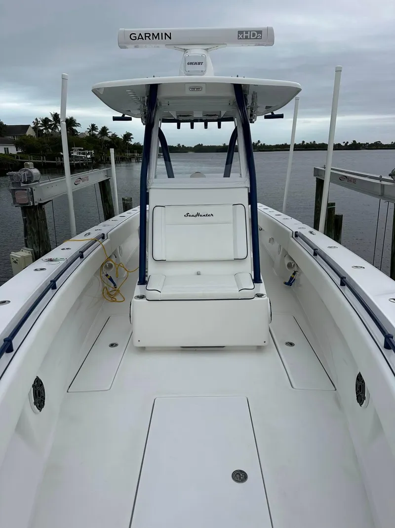 Slide: The Image of 2013 SeaHunter 35 Tournament boat with Garmin radar, docked by a calm waterfront. - 14