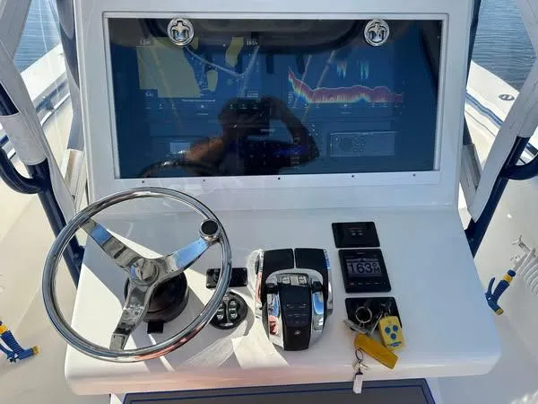 Slide: The Image of Control panel of 2013 SeaHunter 35 Tournament boat with steering wheel and navigation display. - 15