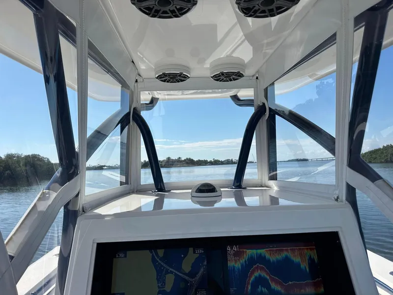 Slide: The Image of Interior view of 2013 SeaHunter 35 Tournament boat with navigation display and clear sky. - 16