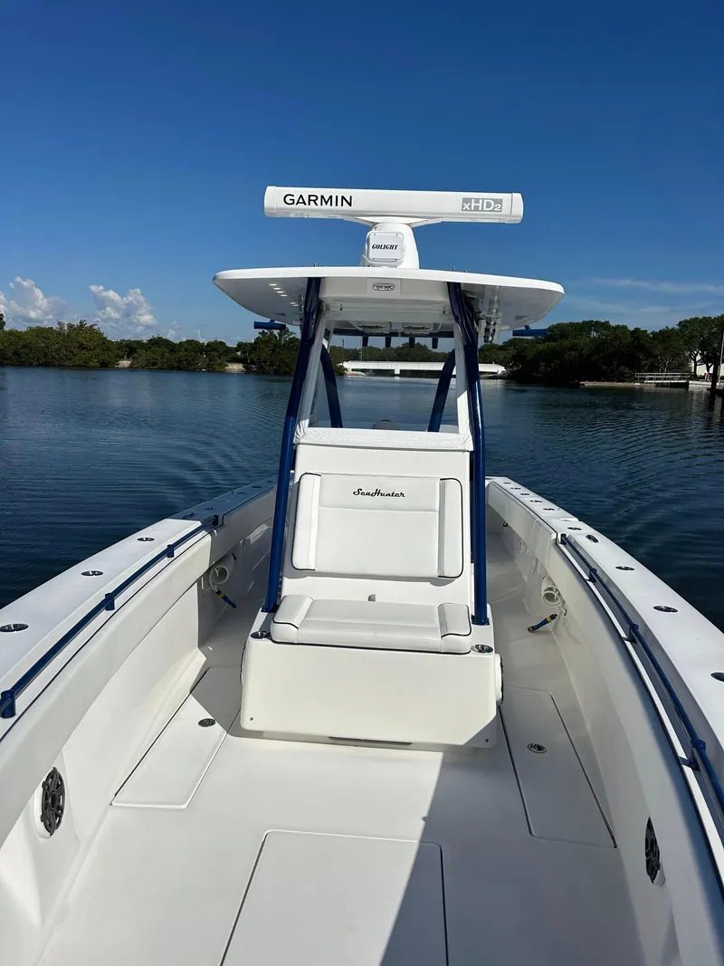 Slide: The Image of 2013 SeaHunter 35 Tournament boat on calm water, featuring Garmin radar. - 17