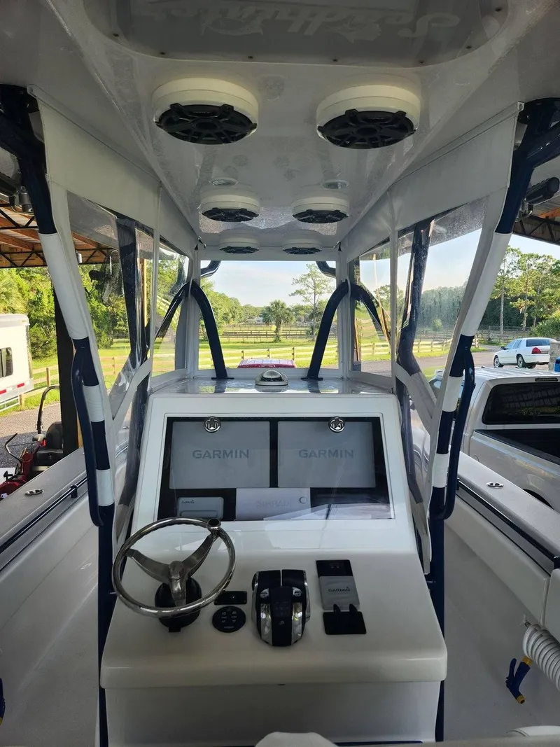 Slide: The Image of 2013 SeaHunter 35 Tournament boat cockpit with Garmin navigation system and steering wheel. - 2