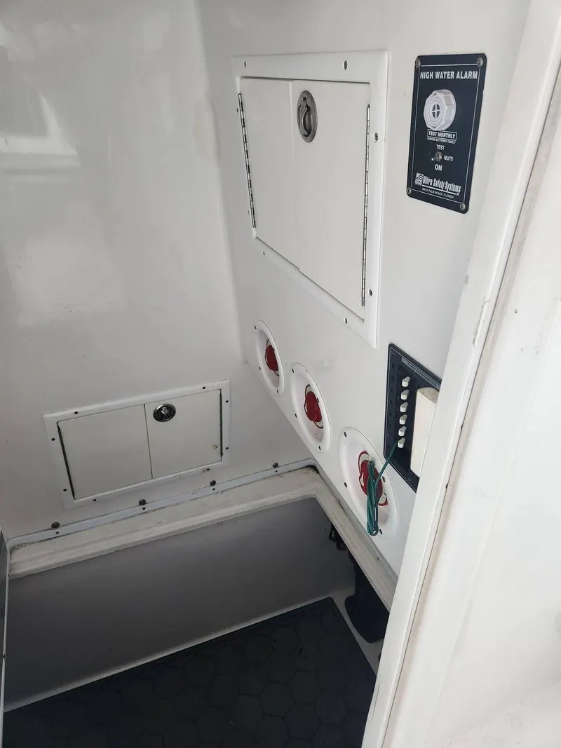 Slide: The Image of Interior view of a 2013 SeaHunter 35 Tournament boat, featuring control panels and storage compartments. - 20